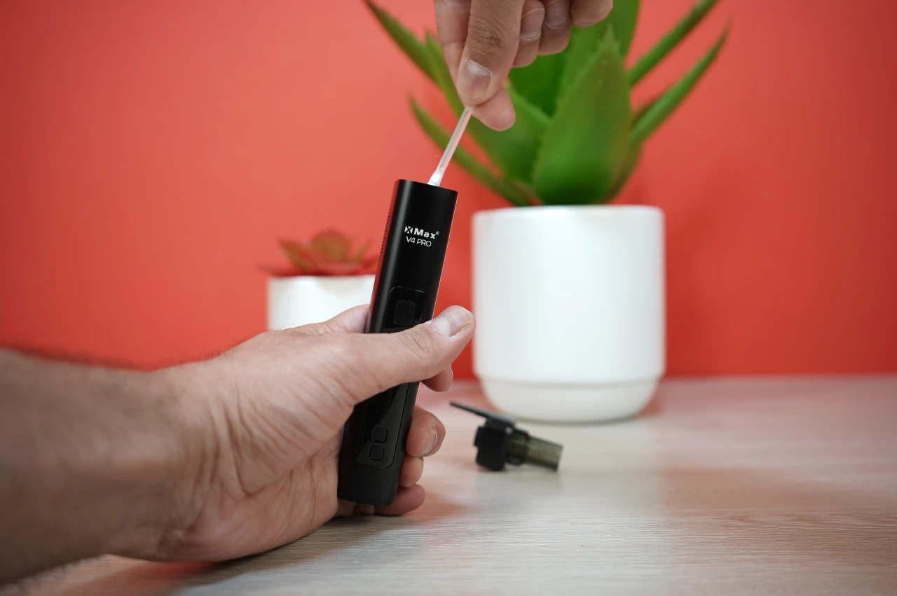 Using a cleaning brush to maintain the XMAX V4 Pro heating chamber