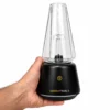 Hand holding Tronian Omegatron 2 black concentrate vaporizer with clear glass cup attachment